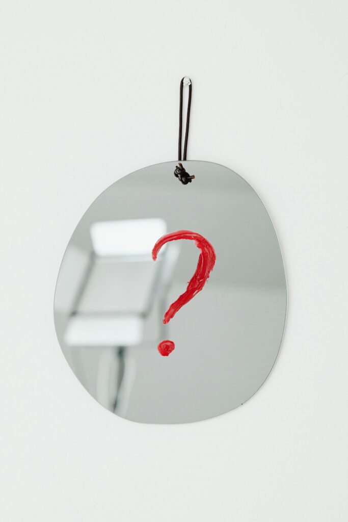 Mirror with a red question mark symbolizing a conceptual and reflective theme.
